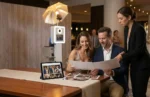 Clients reviewing original photo booth event files and prints for a raw media add-on upgrade