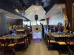 Self-serve digital photo booth setup at a celebration venue with tables and decor, representing the Keep It Simple package from beÜtiful Pixels.