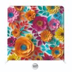 Colorful floral photo booth backdrop with bold layered flowers and vibrant leaf accents for festive event styling.