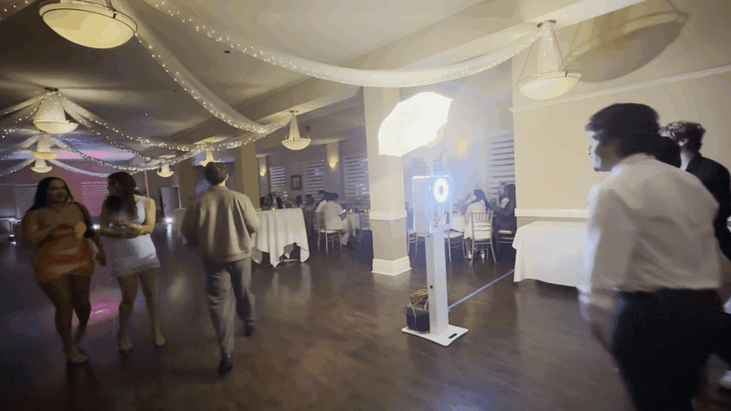 Modern digital photo booth placed inside a restaurant-style event space, showing a simple and polished setup for guest photos.