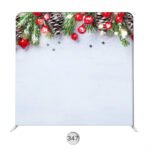 Holiday photo booth backdrop with evergreen branches, pinecones, red berries, and a snowy white background.