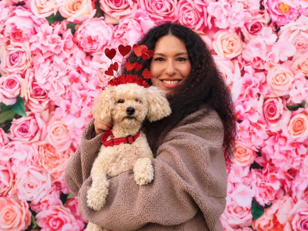 Guest posing with a dog at a beÜtiful Pixels photo booth event